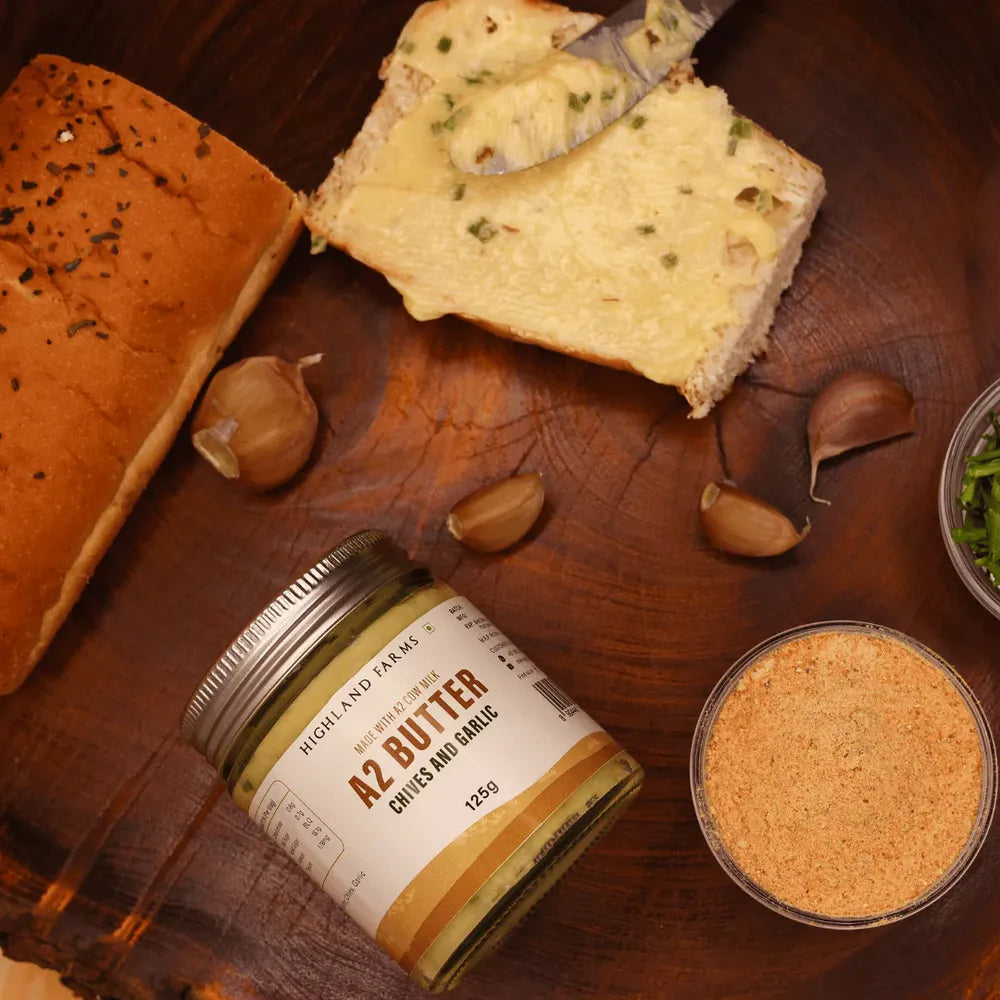 A2 chives and garlic butter spread on bread with Highland Farms jar creamy flavored butter for cooking and snacks