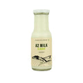 Highland Farms A2 elaichi flavored milk in glass bottle made from desi cow milk, natural and preservative free