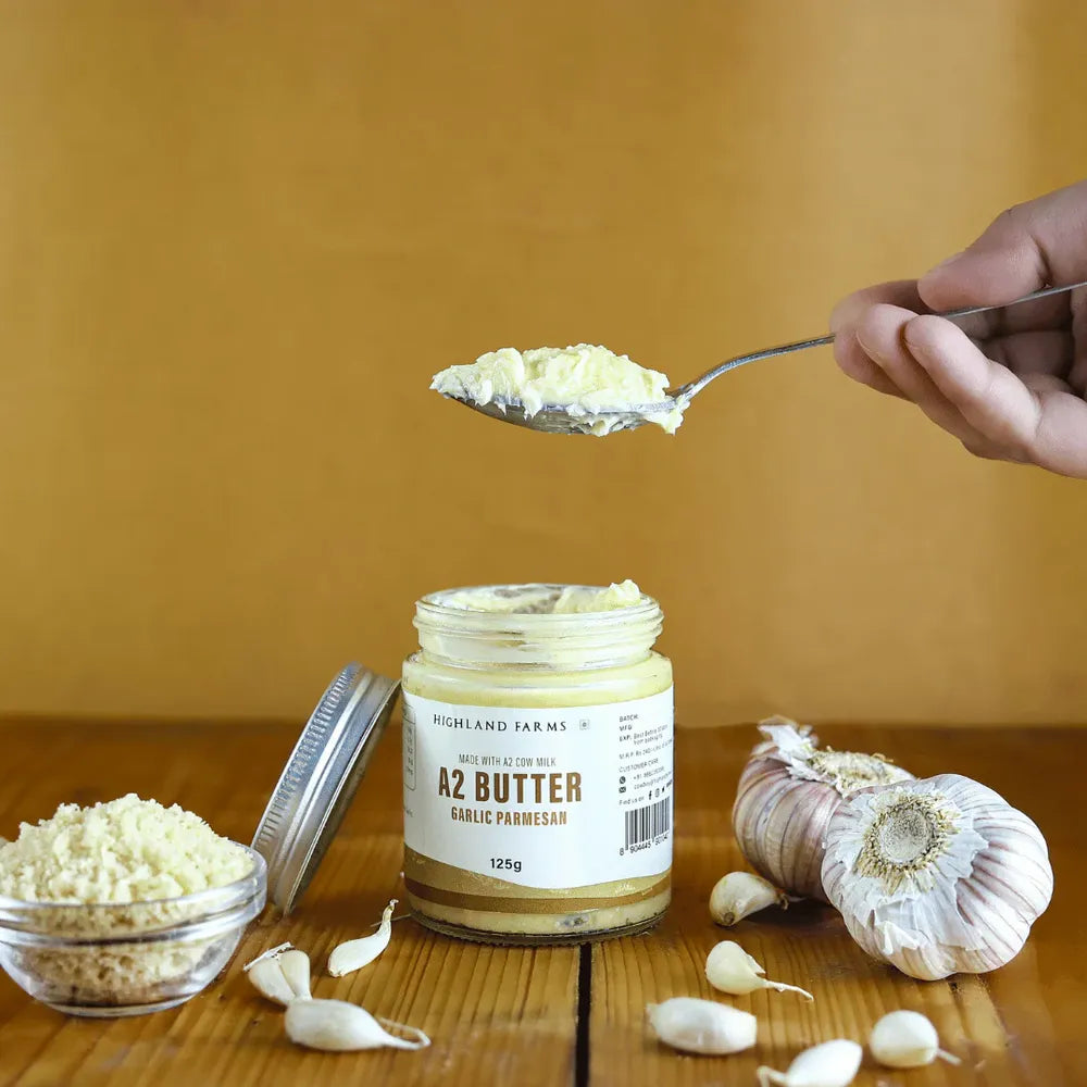 A2 garlic parmesan butter spoon scoop with fresh garlic and jar Highland Farms creamy butter for bread and pasta