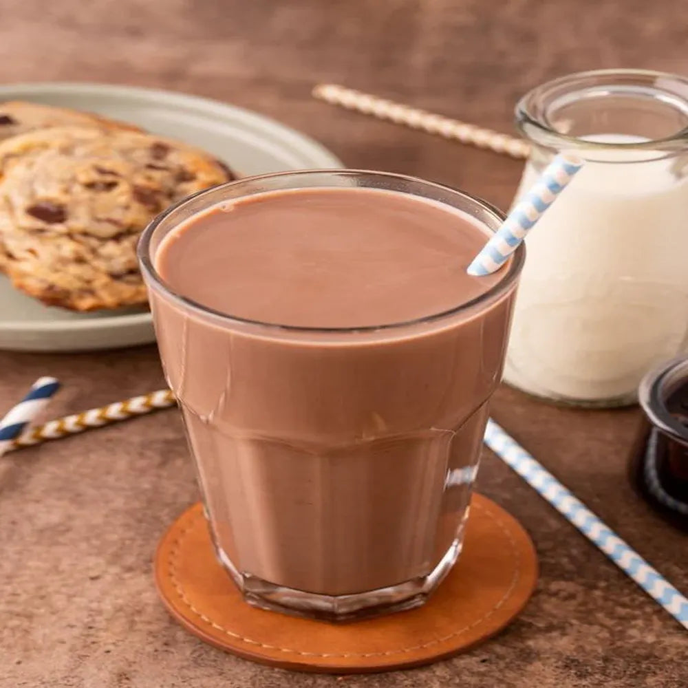 Glass of A2 hot chocolate drink served with cookies showing rich creamy texture perfect evening drink for comfort and energy