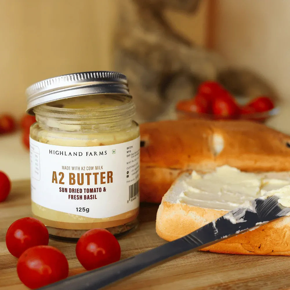 A2 sundried tomato basil butter spread on bread with knife and cherry tomatoes gourmet butter for garlic bread and snacks