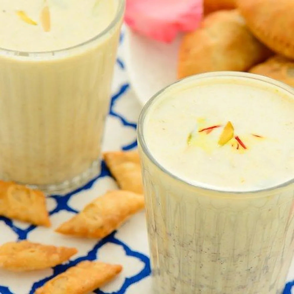 traditional thandai milk drink with saffron almonds and spices made from A2 cow milk creamy refreshing summer drink”