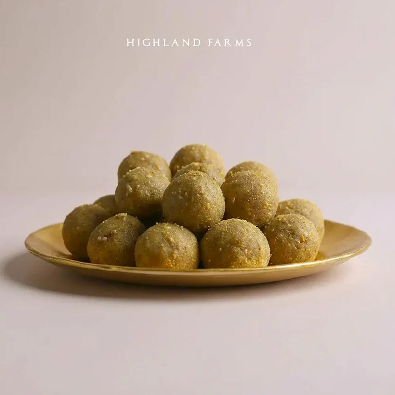 Bajra laddu millet pinni served on plate healthy winter sweet made with ghee and jaggery