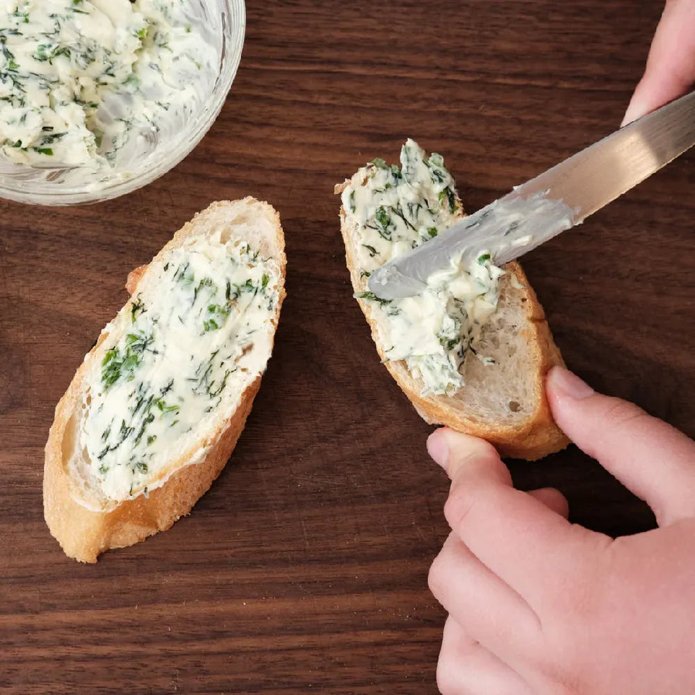 A2 garlic herb butter spread on bread showing creamy texture and usage Highland Farms flavoured butter